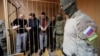 RUSSIA -- Detained crew members of Ukrainian naval ships, which were seized by Russia's FSB security service in November 2018, stand inside a defendants' cage as they attend a court hearing in Moscow, January 15, 2019