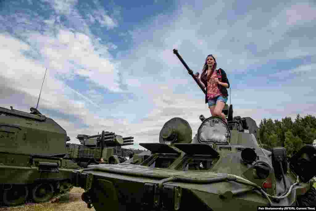 Девушка на фоне российской военной техники на фестивале "Нашествие-2015"